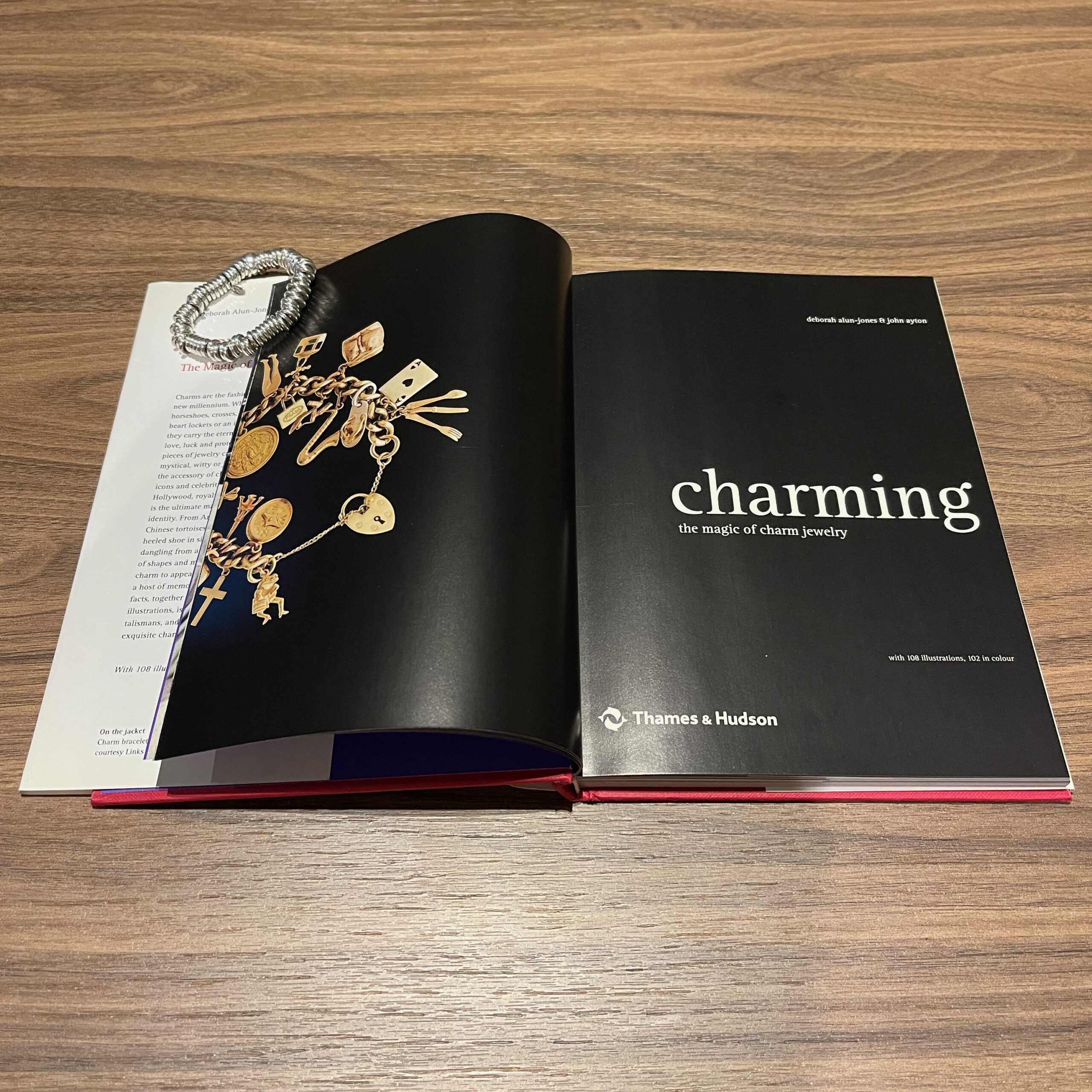 Pages of Charming: The Magic of Charm Jewelry held open with a Links of London Sweetie Bracelet.