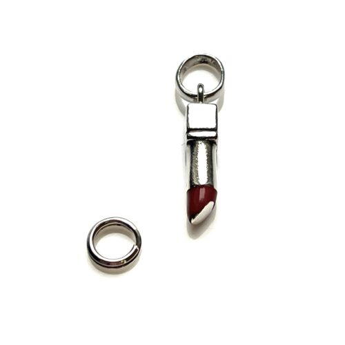 Close-up of Links of London sterling silver lipstick charm with worn red enamel.