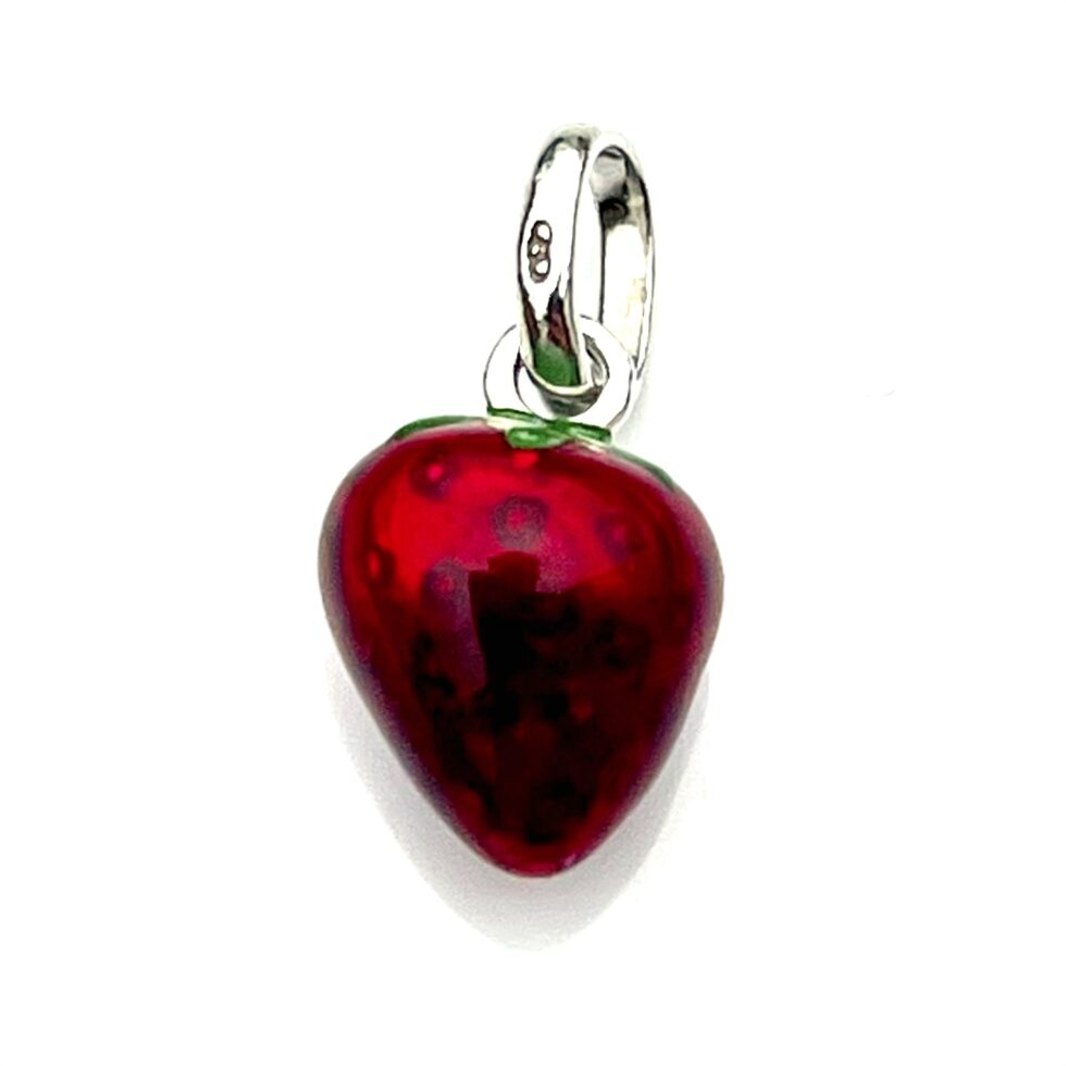 High-resolution shot of the strawberry charm’s red and green enamel