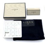 Vintage Links of London puzzle stored in a black cotton pouch.