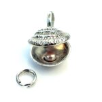 Polished oyster shell charm ready for attachment to a bracelet or necklace