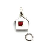 Side view of the sterling silver house charm showcasing its polished finish