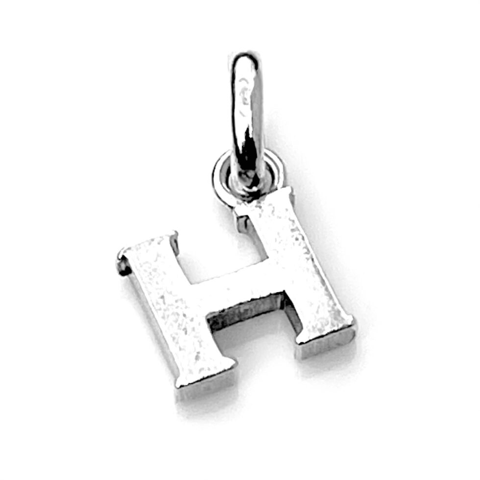 A close-up of the polished sterling silver finish on the Letter 'H' Charm.