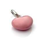 Professionally cleaned charm showing signs of vintage wear on the enamel.