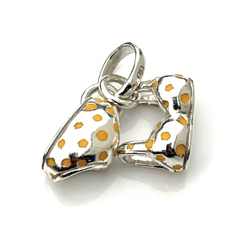 The bikini charm photographed in natural light to highlight its enamel details.