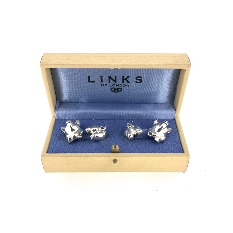 boxed 1994 Links of London Pig Cufflinks showing the polished front and back pig sections.