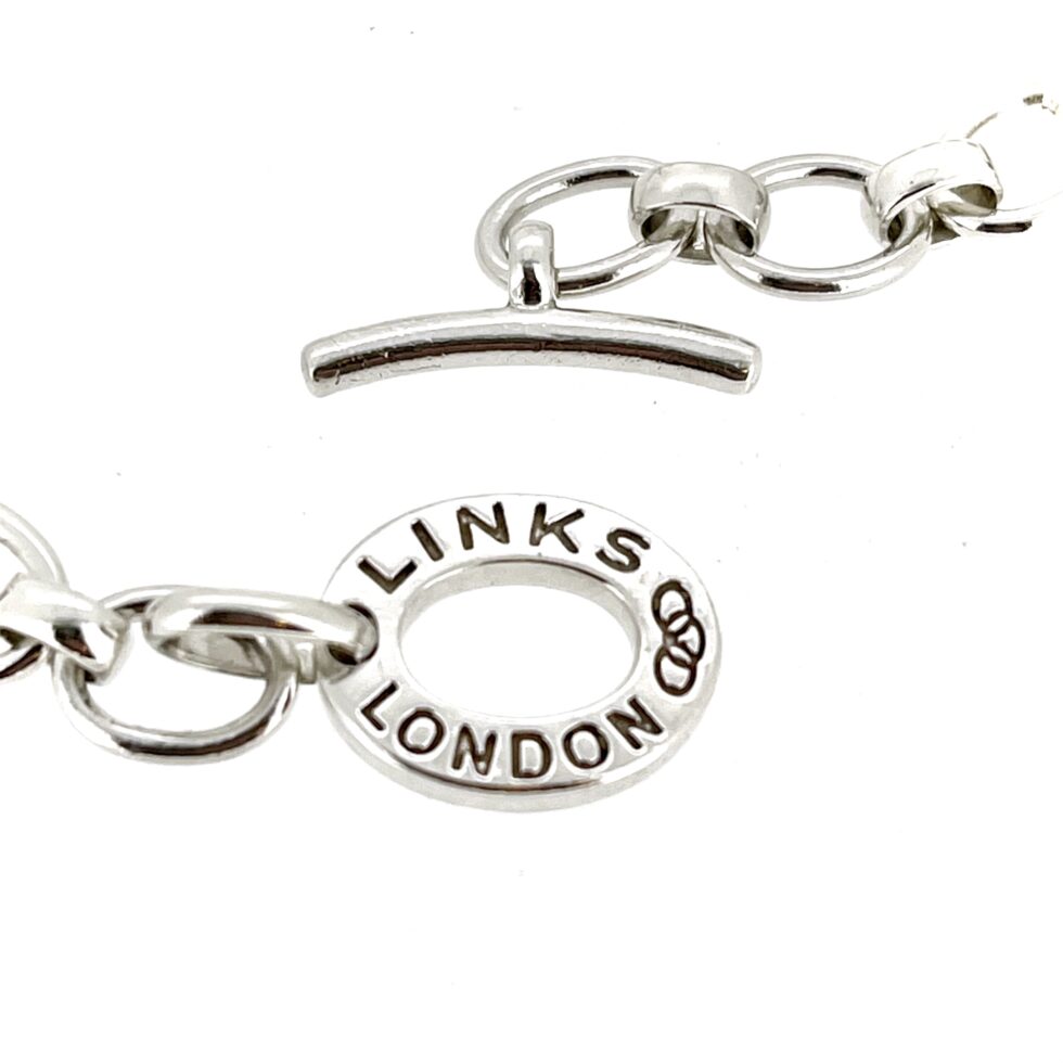 Side profile highlighting the curved T-bar clasp.