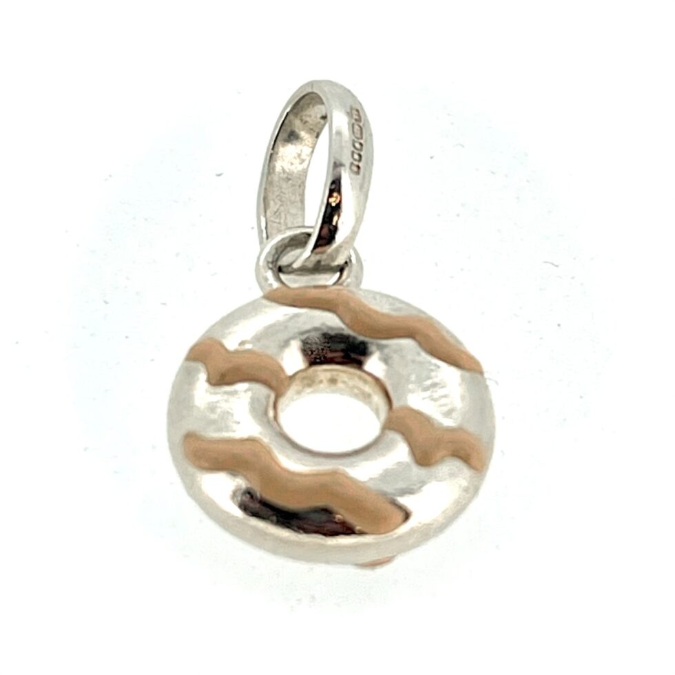 Side view of the charm showcasing the pink enamel drizzle detailing.