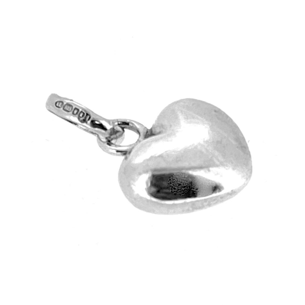 Side view of the heart charm showing its polished finish.