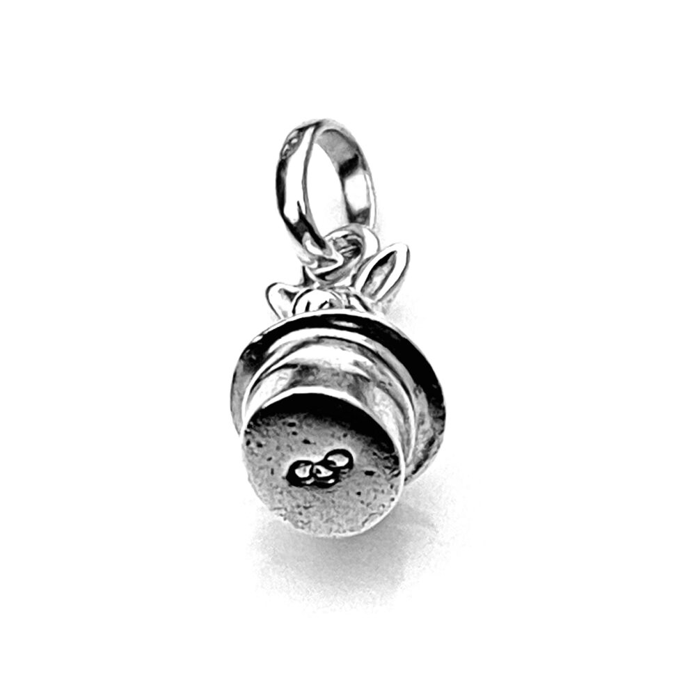 Close-up of the charm’s engraved details and polished surface.