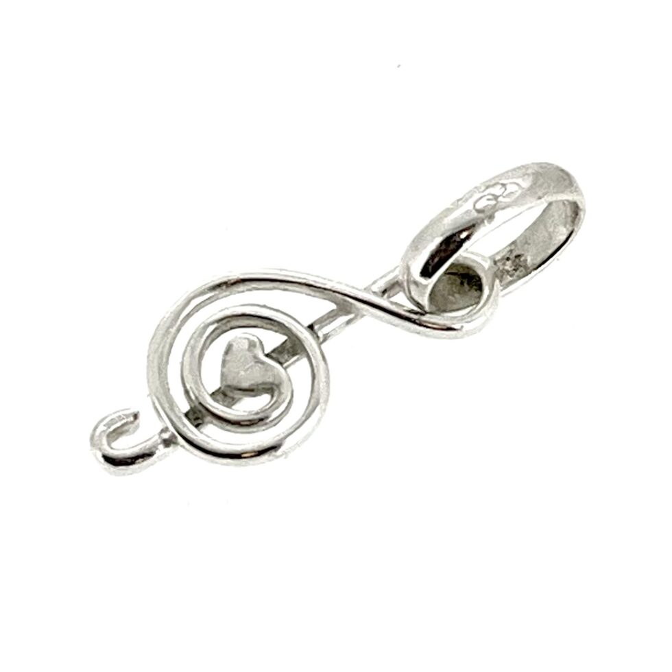 Close-up of the heart motif at the centre of the treble clef.