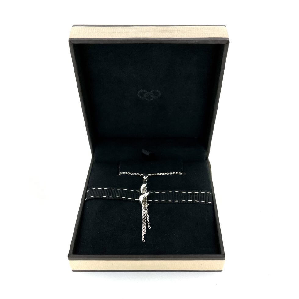 Shown in the original Links of London box with visible wear.