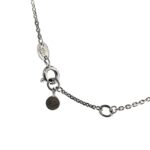 Detailed shot of the hallmark tag and branded round tag.and clasp