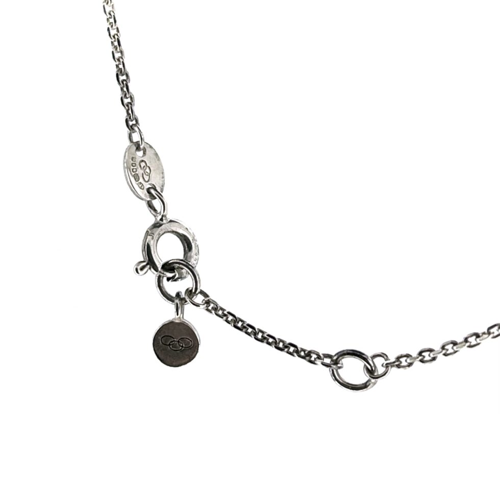 Detailed shot of the hallmark tag and branded round tag.and clasp