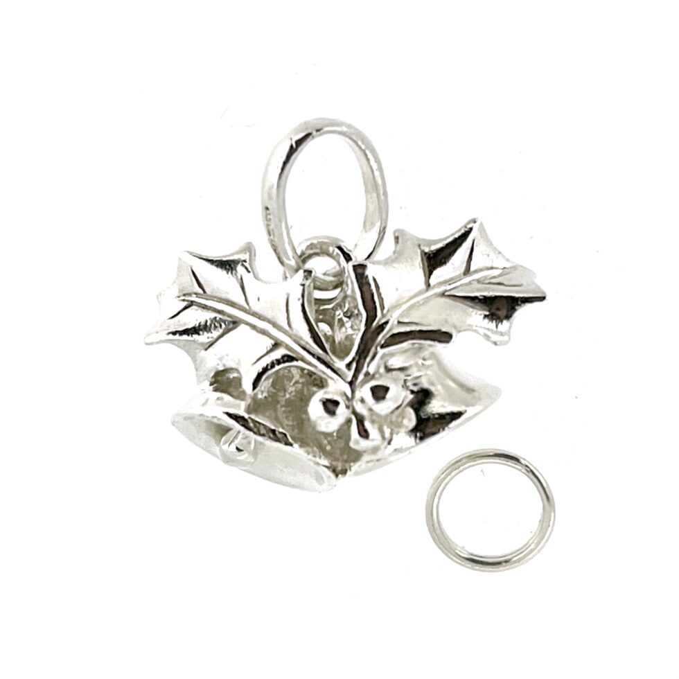 Close-up of the restored sterling silver surface and holly design.