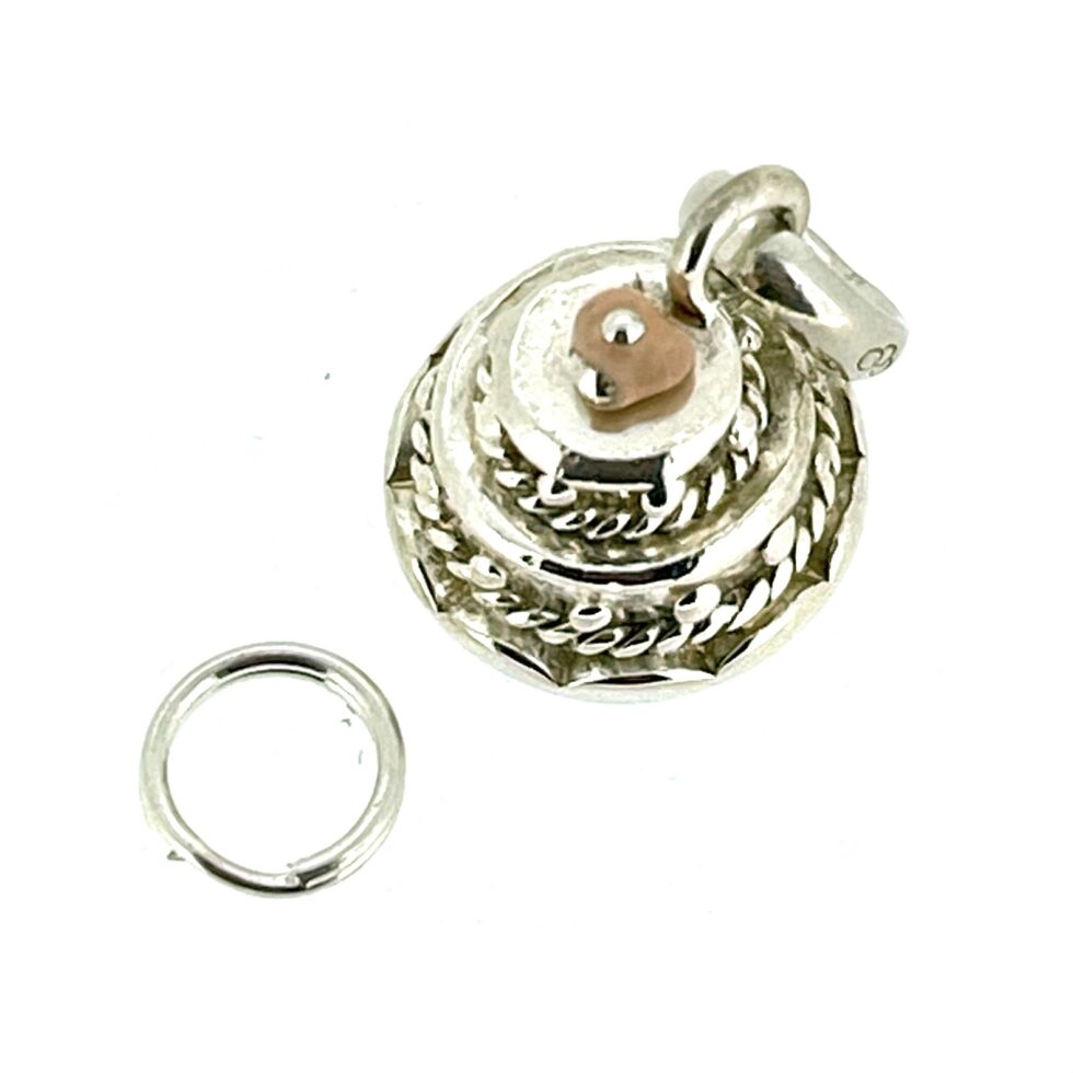 Vintage Links of London Wedding Cake Charm highlighting its polished silver finish.