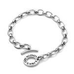 Side view highlighting the oval toggle clasp and curved T-bar.