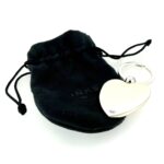 The keyring shown in its original black fabric pouch.