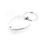 Minimalist shot highlighting the reflective finish of the silver-plated heart.