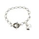 Side view showing the polished heart charm and delicate oval links.