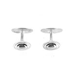 Detailed shot of the engraved Links of London three-ring logo on the cufflink backs.