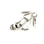 The restored charm reflecting soft light, showcasing its bright and smooth finish.