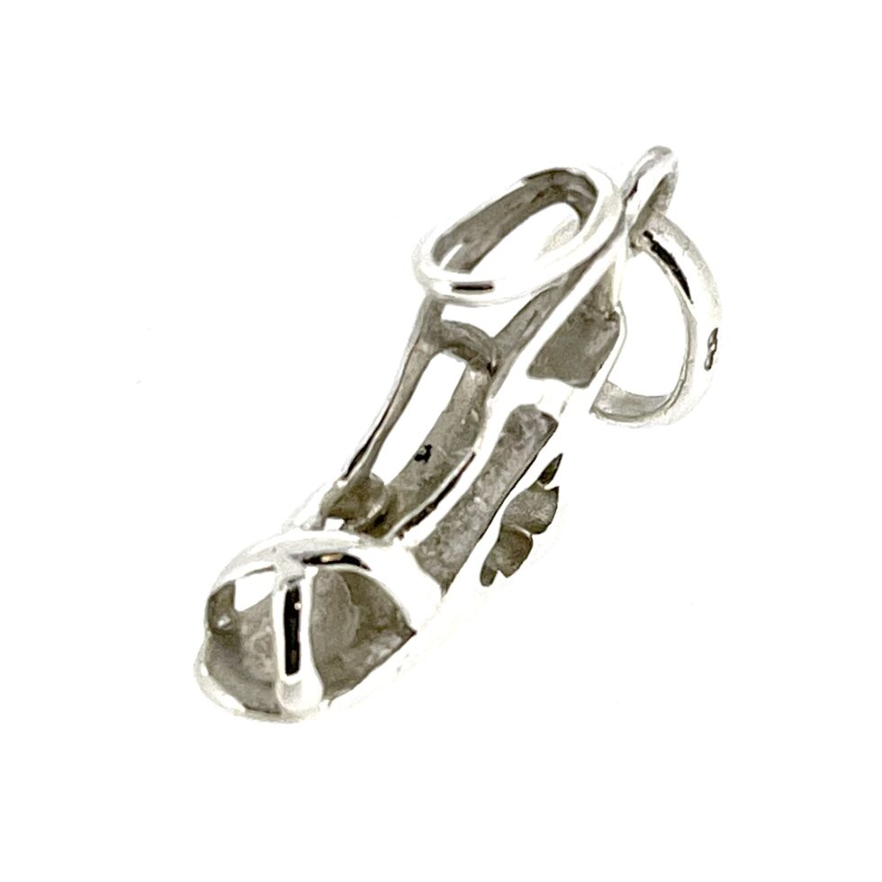 Top-down view showing the intricate floral cutout in the wedge heel.