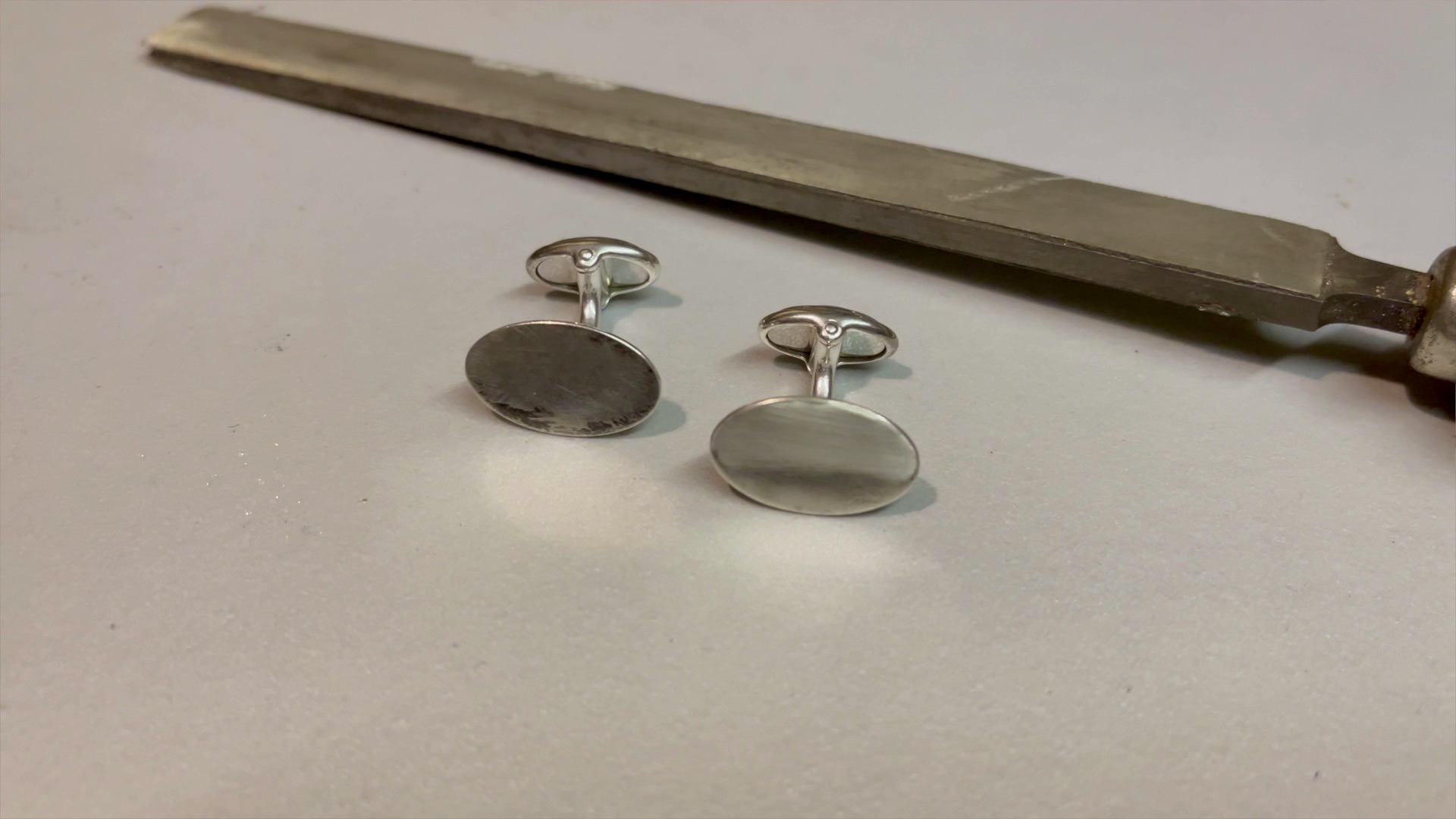 Using an emery buff stick to pre polish cufflinks