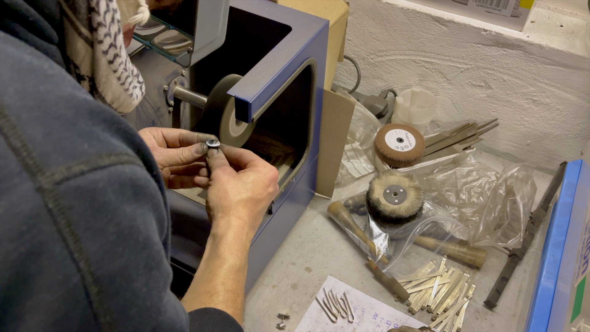 Hand polishing sterling silver cufflinks to a mirror finish.