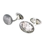 Close-up of tarnished Links of London cufflinks before cleaning and polishing.