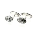 Close-up of tarnished Links of London cufflinks before cleaning and polishing.