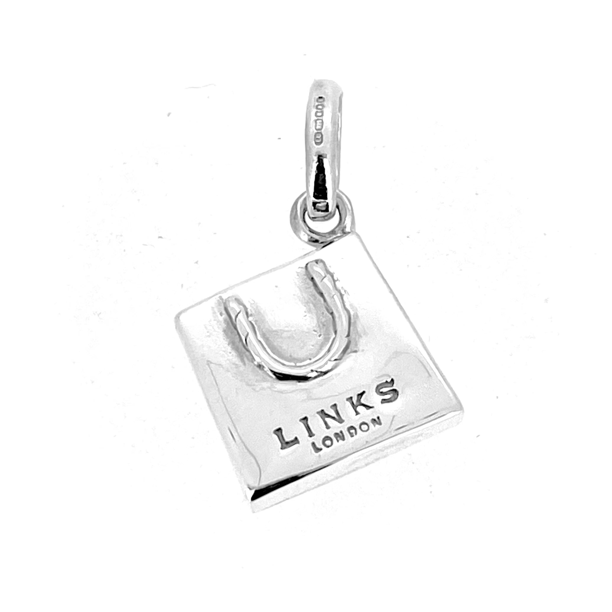 Close-up of the 2010 Links of London Shopping Bag Charm, inspired by Bloomingdale’s Brown Bag.
