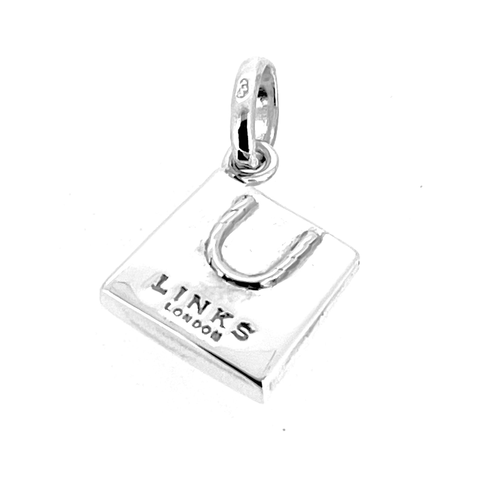 Overhead shot of the miniature shopping bag charm, a nod to luxury retail culture.