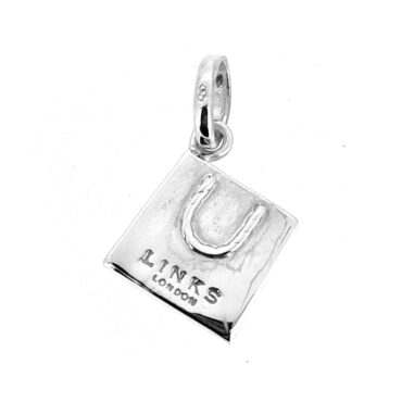 Side view of the sterling silver Links shopping bag charm, showcasing its polished finish and iconic shape.