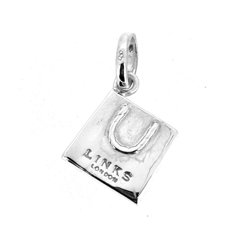 Side view of the sterling silver Links shopping bag charm, showcasing its polished finish and iconic shape.