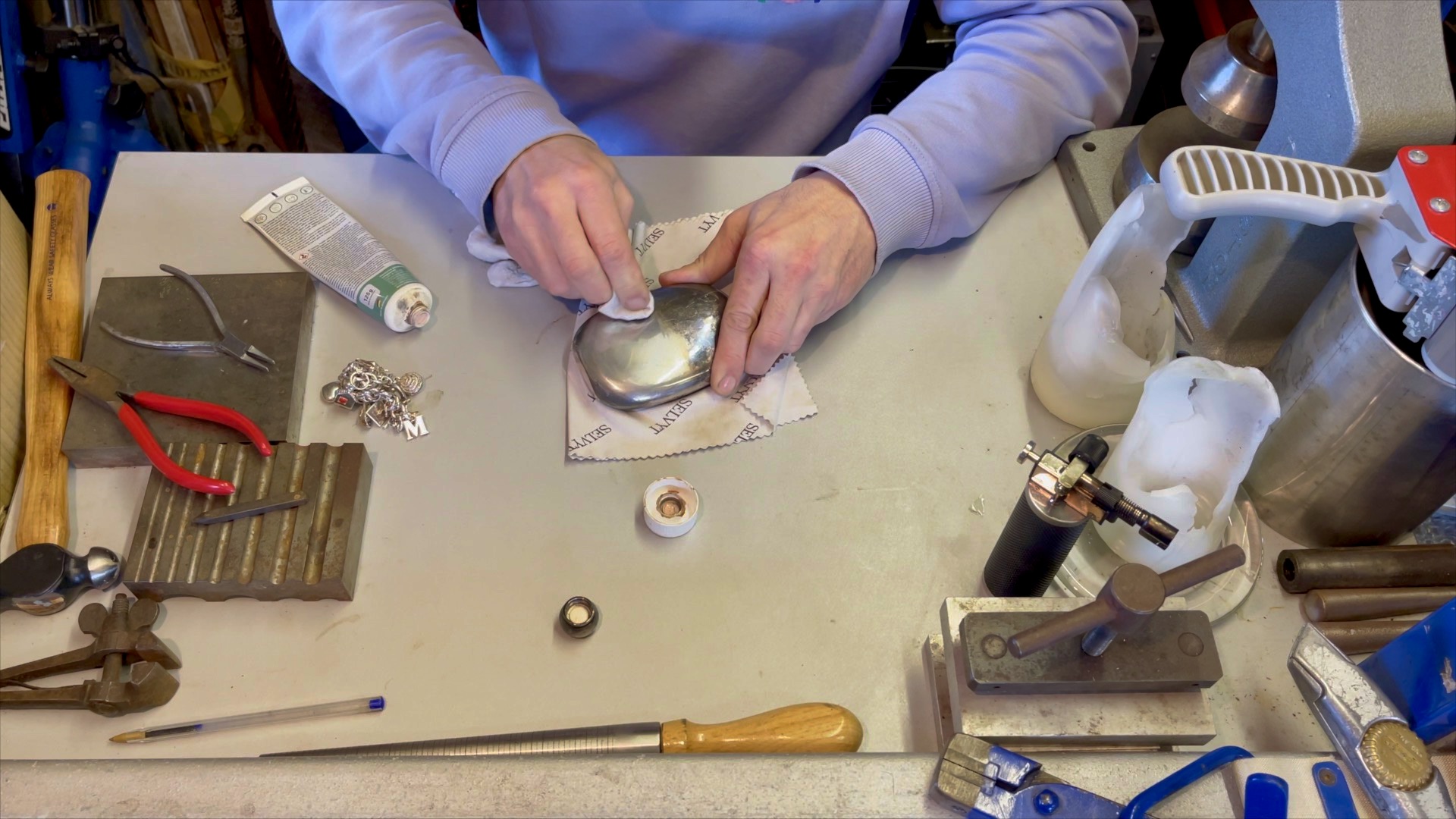 Flask halfway through polishing, with tarnish partially removed