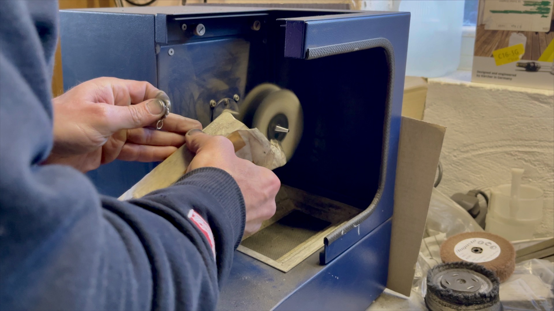 Hand-finishing the charm with a soft mop polishing wheel.