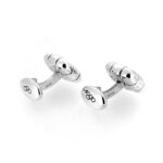 Side view of the cufflinks showing the solid curved bar connector