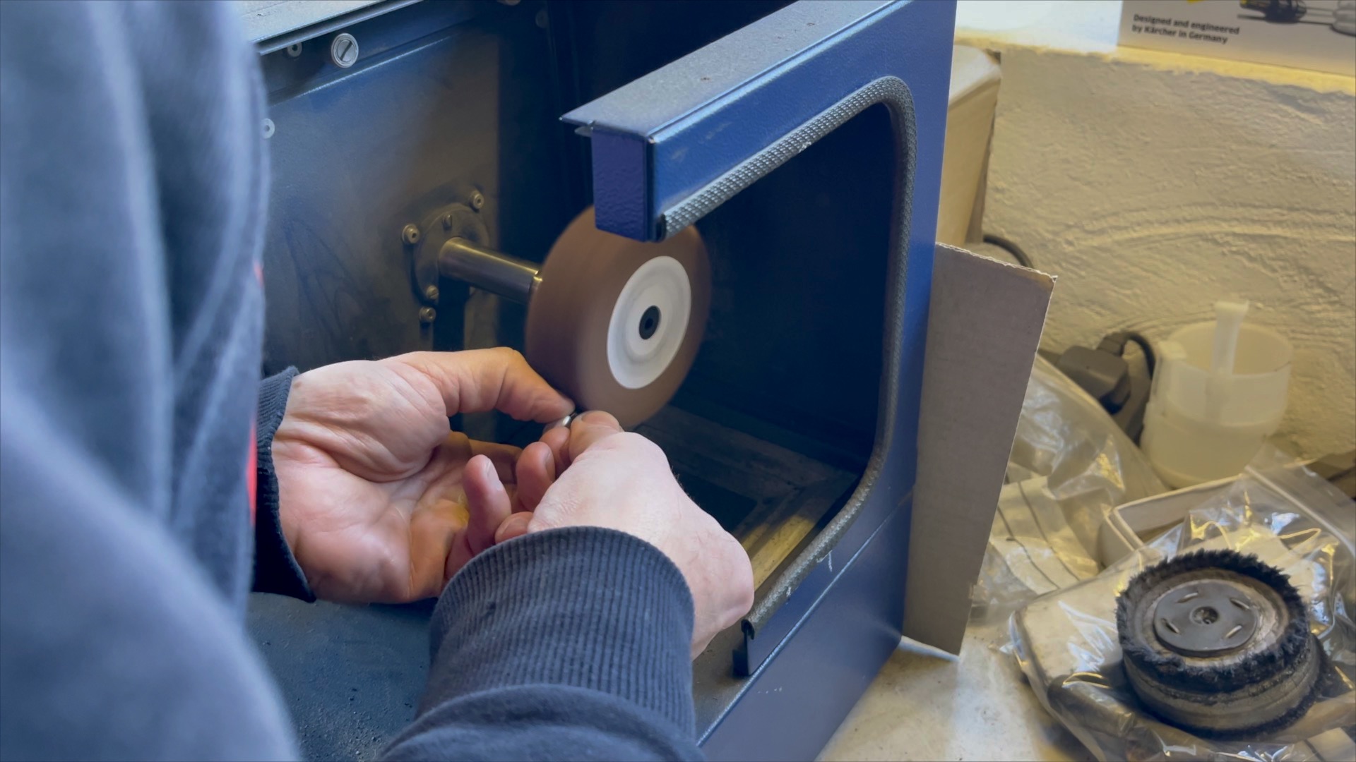 Close-up of the satin polishing wheel removing deep scratches from the heart charm.