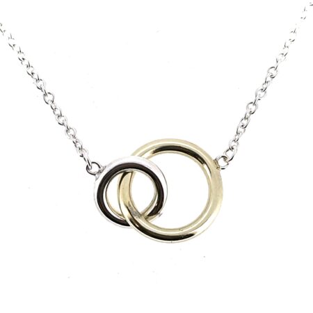 Close-up of interlocking yellow gold and silver rings
