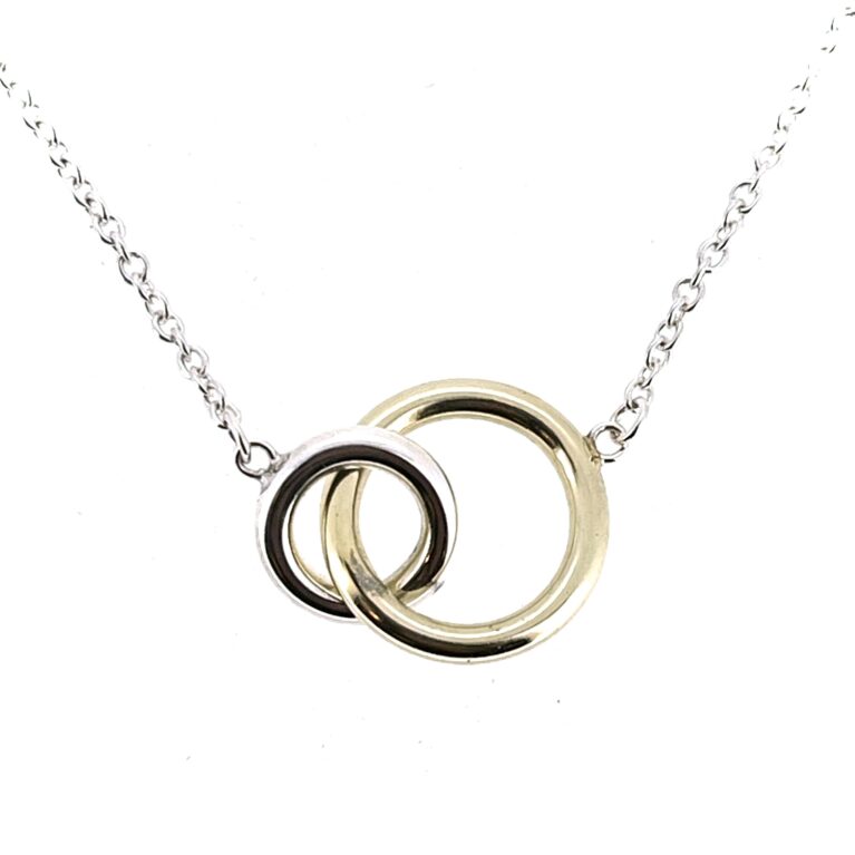 Close-up of interlocking yellow gold and silver rings