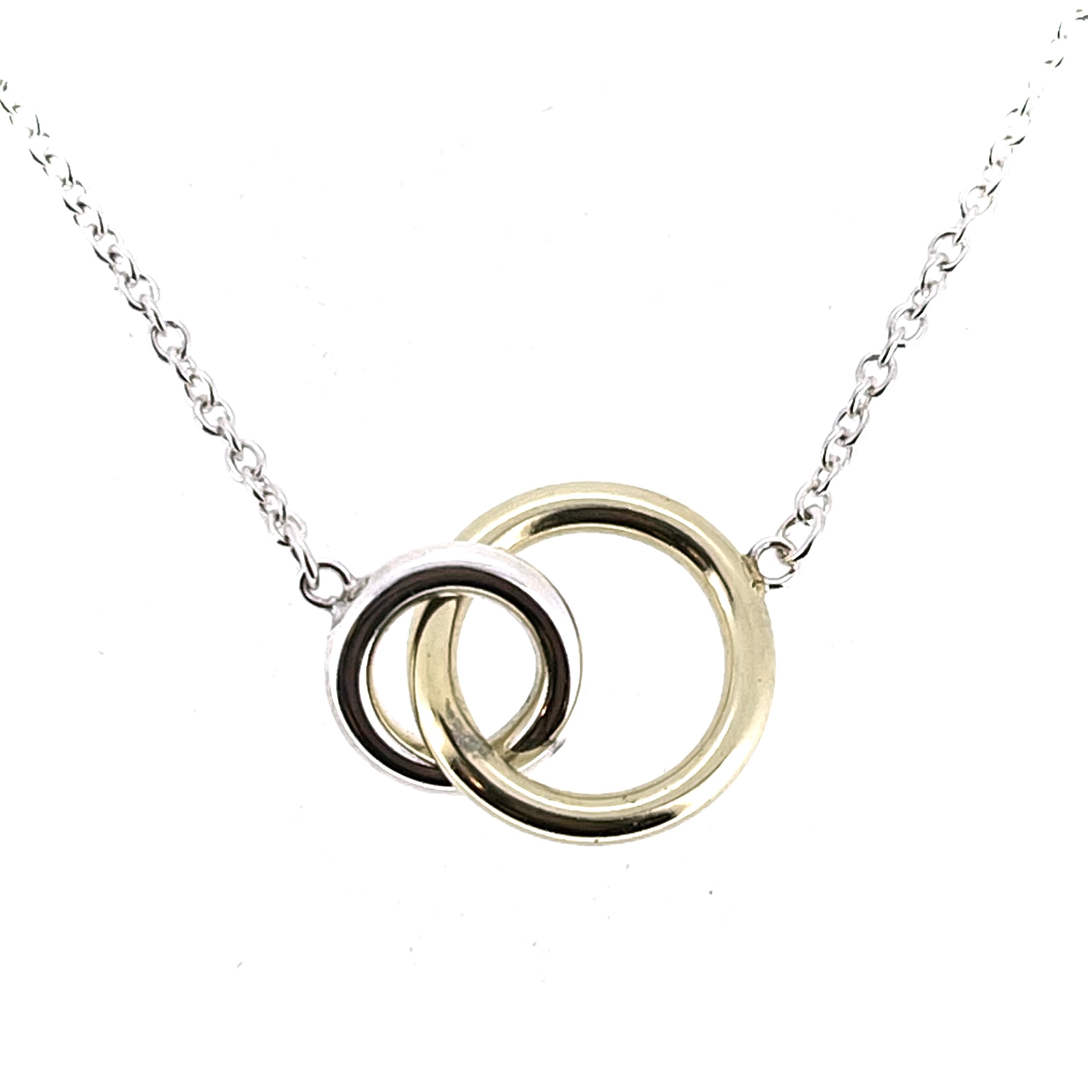 Close-up of interlocking yellow gold and silver rings