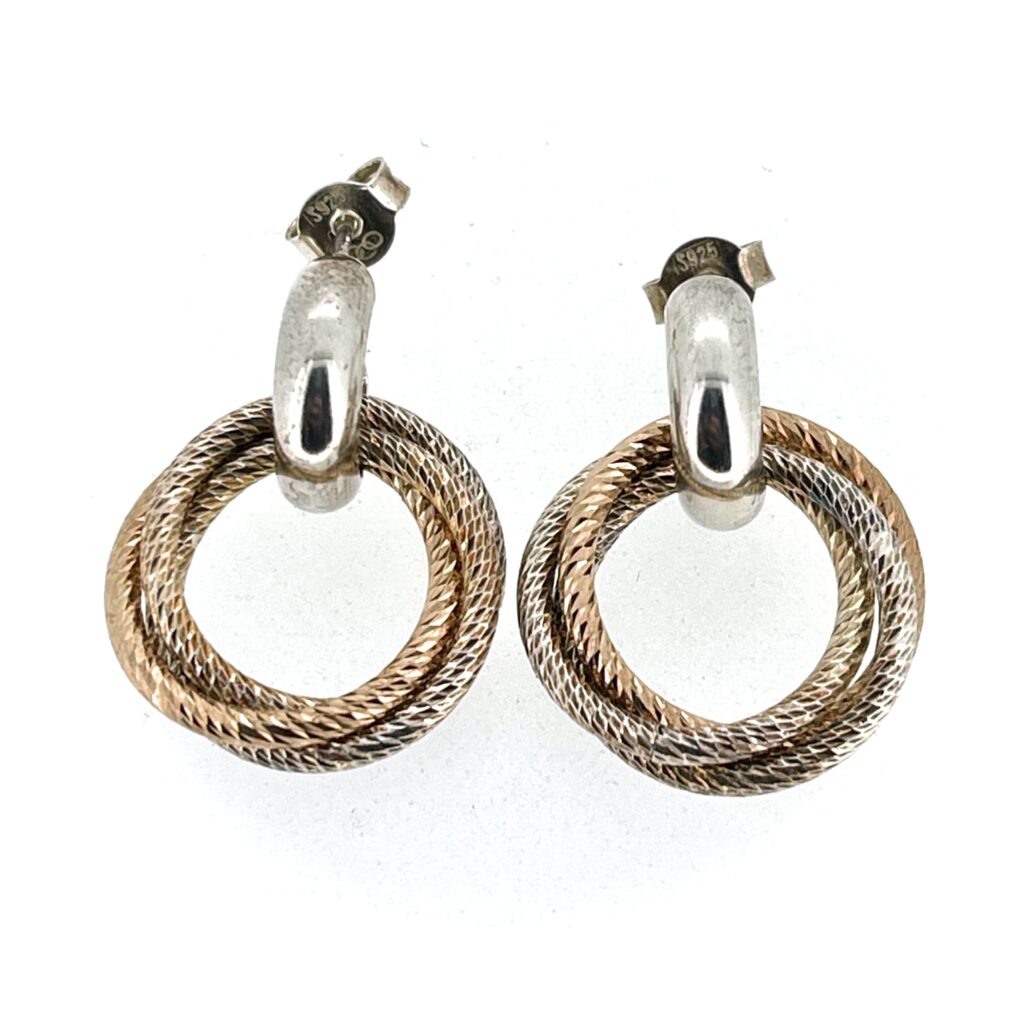 Close-up of two-tone interlocking rings on earrings