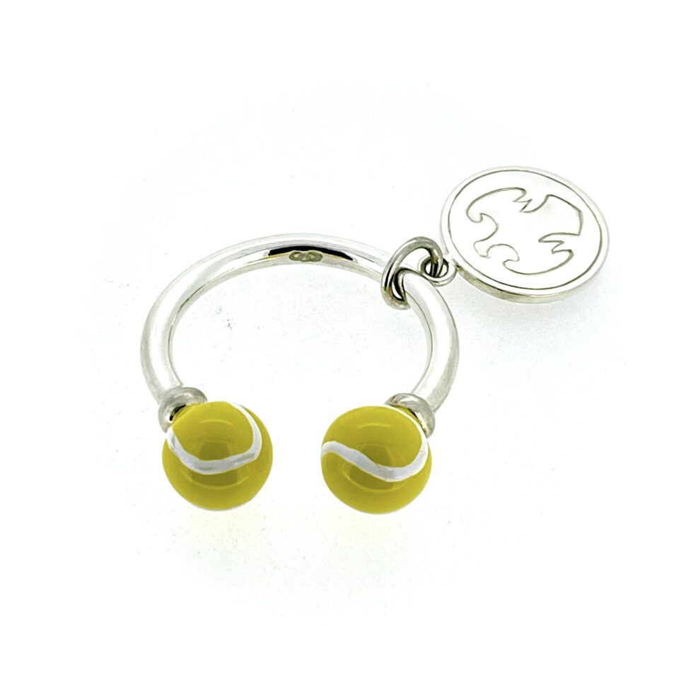 Close-up showing yellow enamel tennis ball detail with white stripe accents.