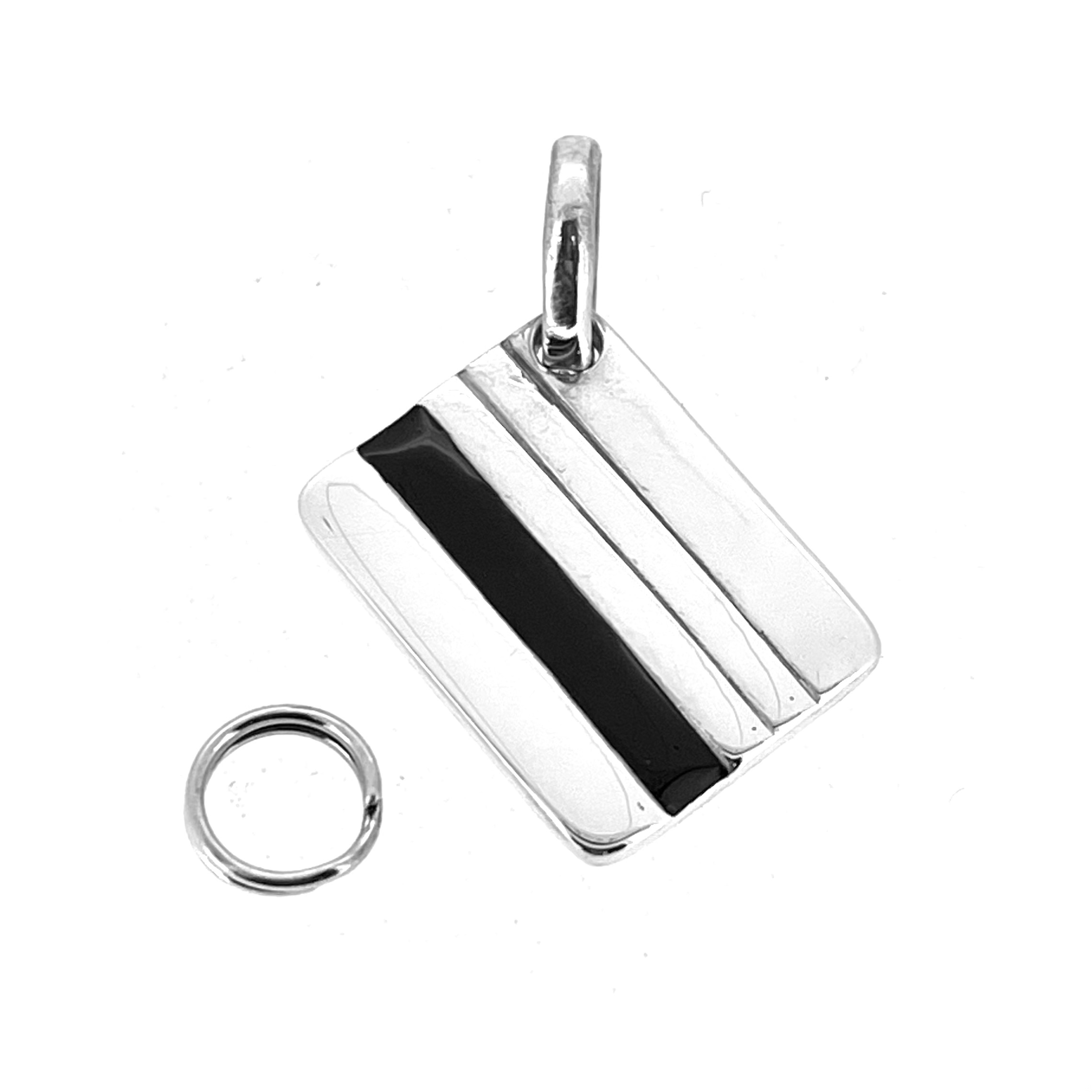 Back of charm showing black enamel strip detail