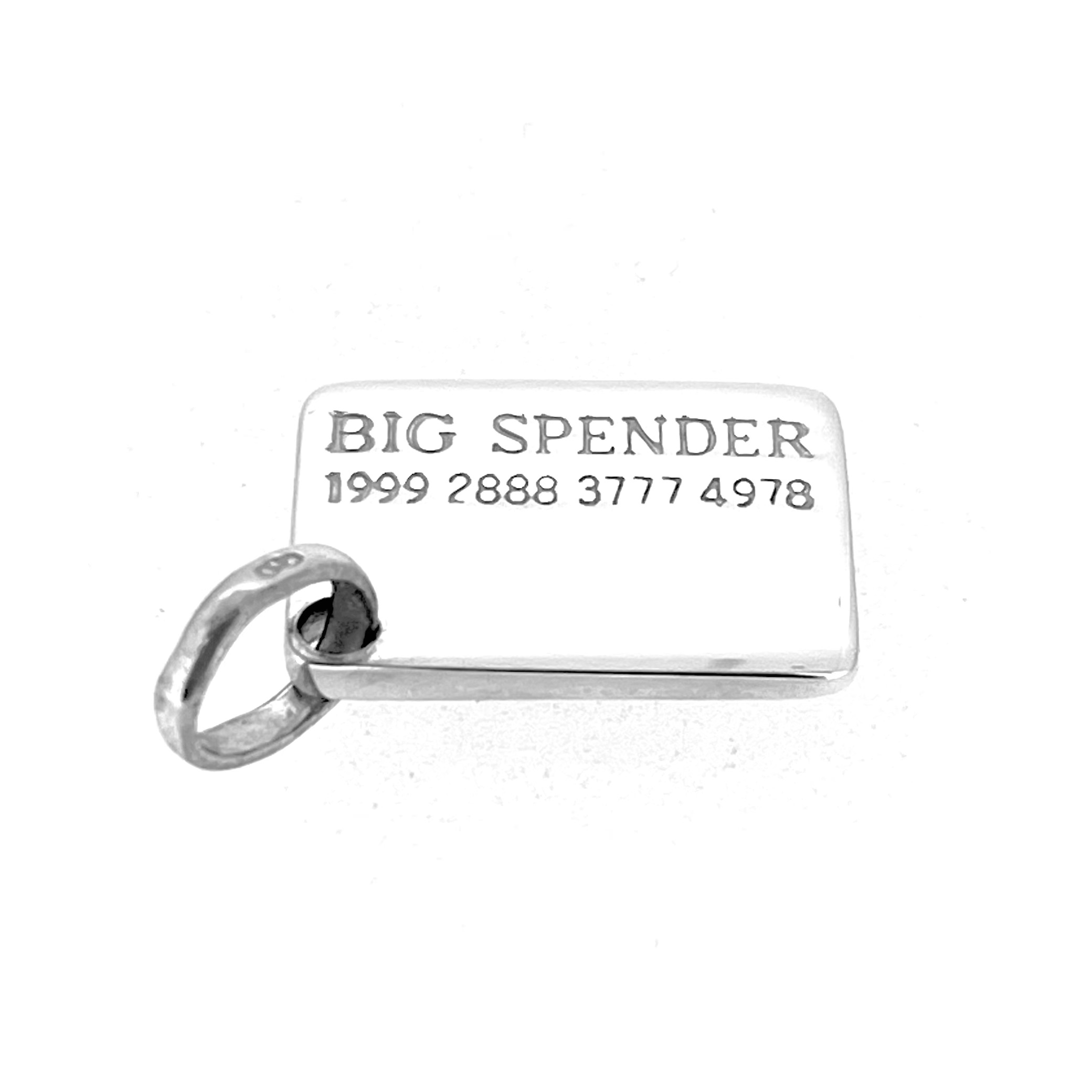Close-up of engraved “BIG SPENDER” with card number