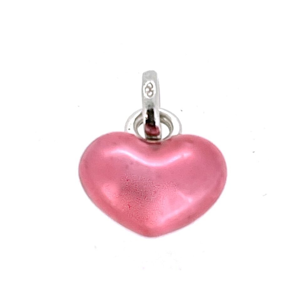 Polished fuchsia enamel heart charm against white background