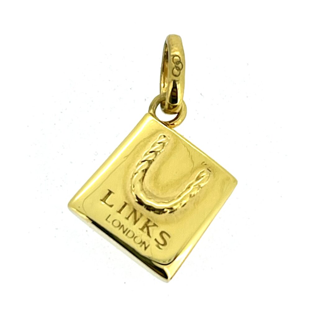 Close-up of engraved LINKS LONDON on charm front.