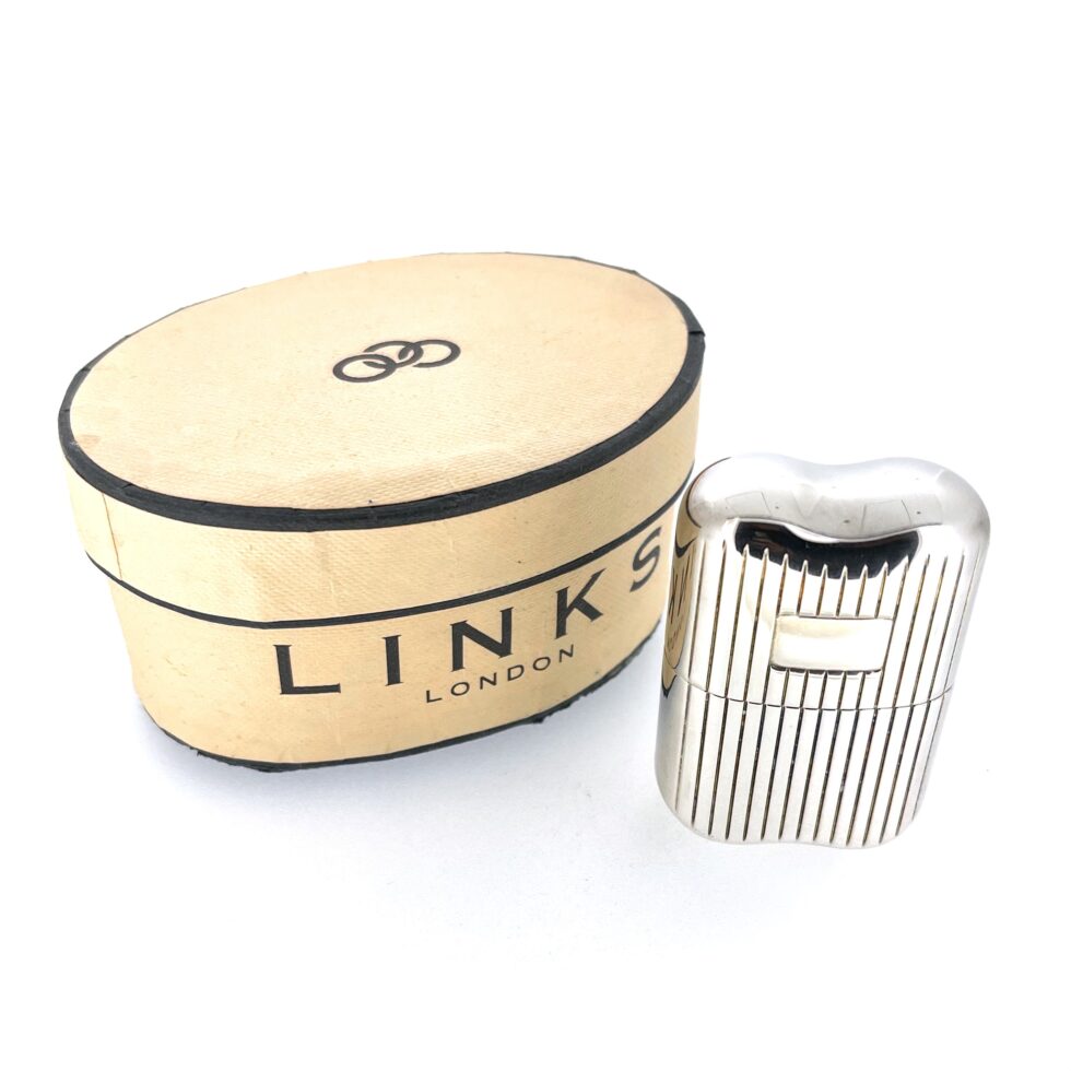 Twin-spray vials displayed beside vintage atomiser case