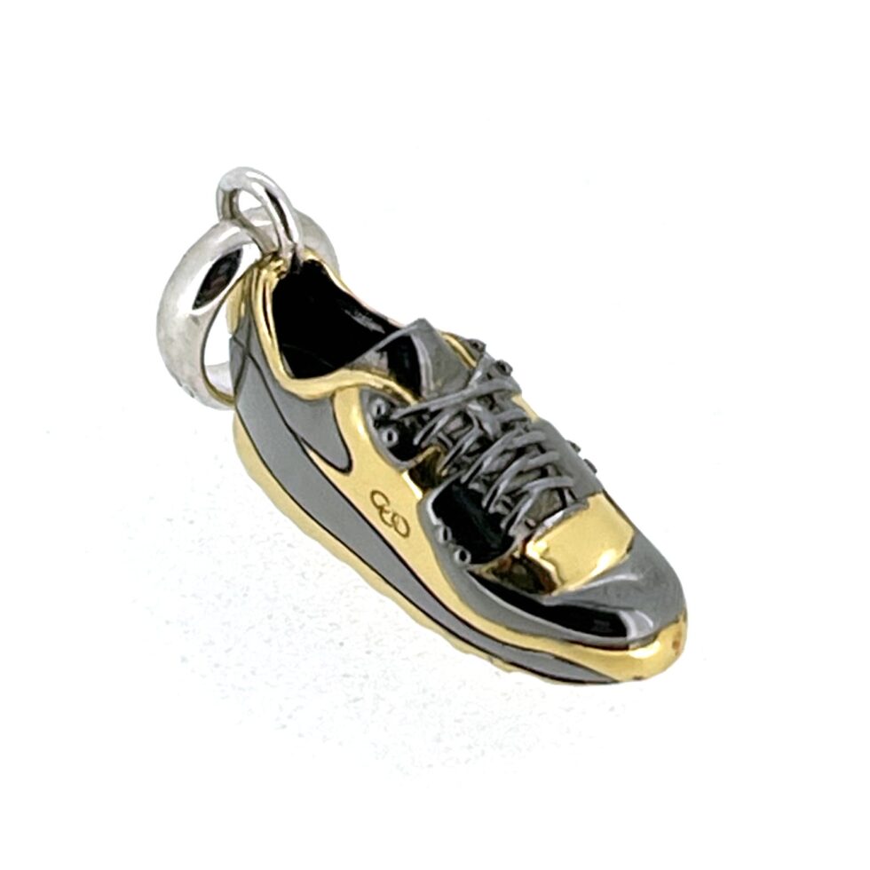 NOS condition black rhodium trainer charm against white background